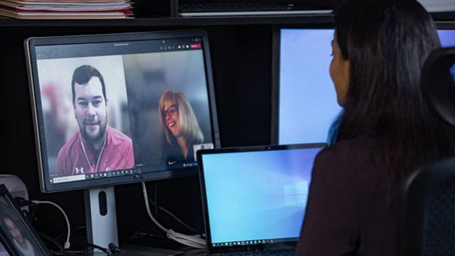 Woman on a video call with two other people