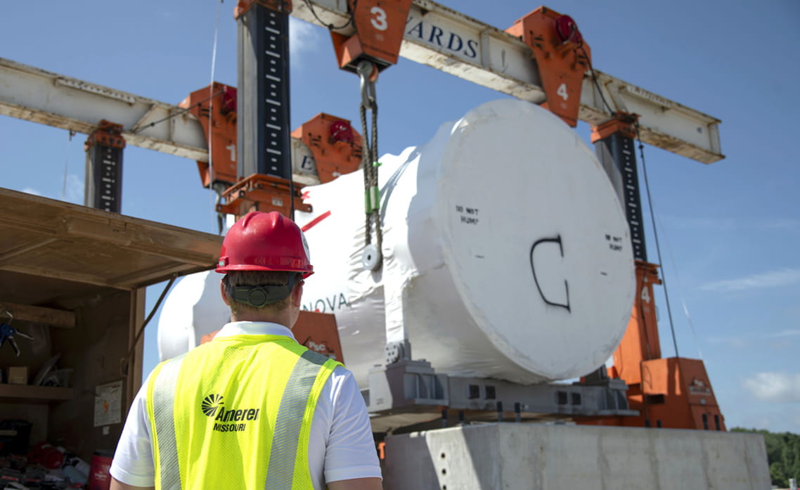 Ameren Missouri employee observes installation of a large energy facility component at a construction site.