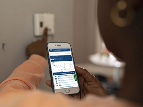 woman using thermostat