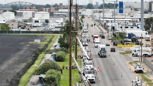 image of crews working to restore power along busy roadway